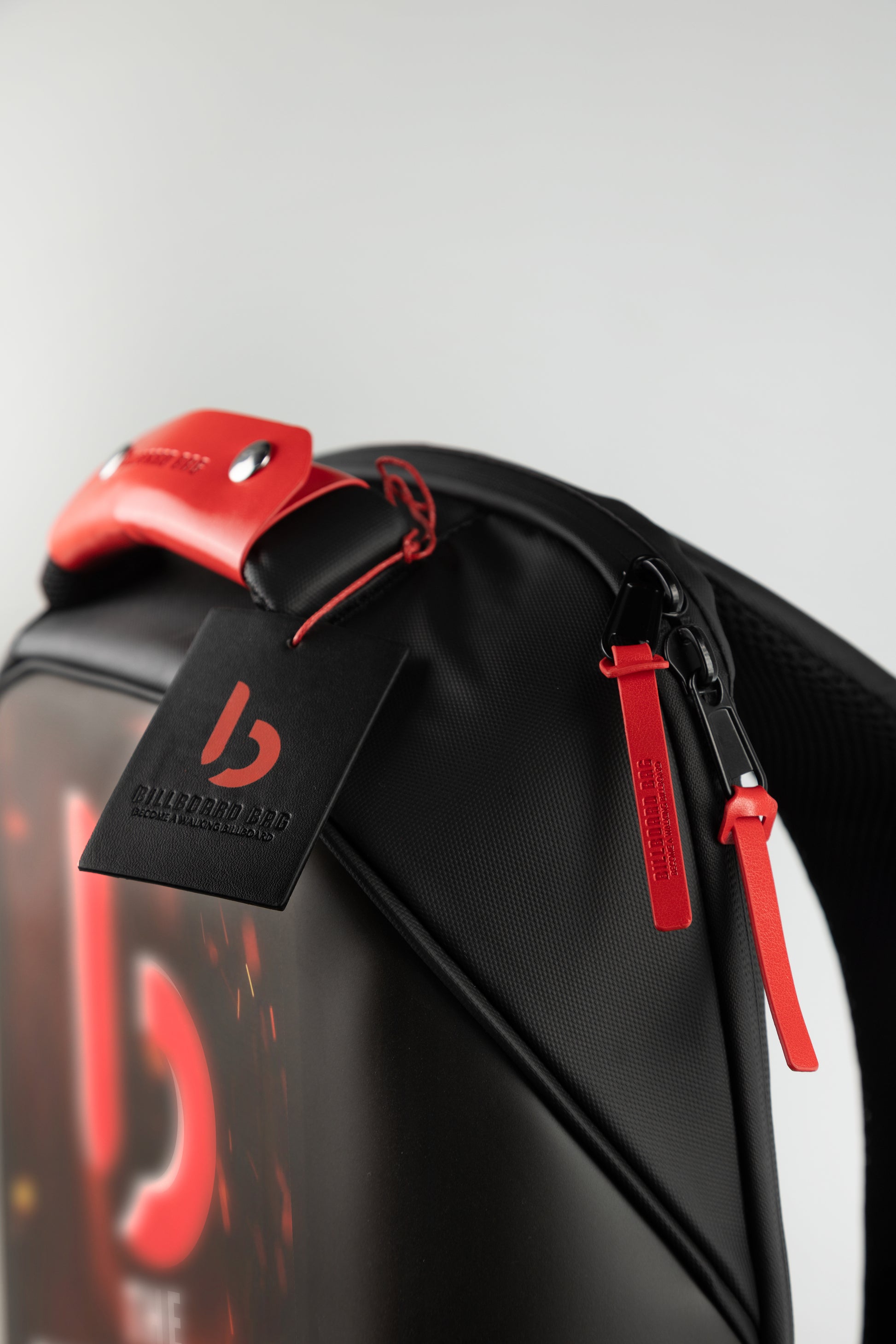 red and Black red eye led backpack with red accents and a billboard bag tag